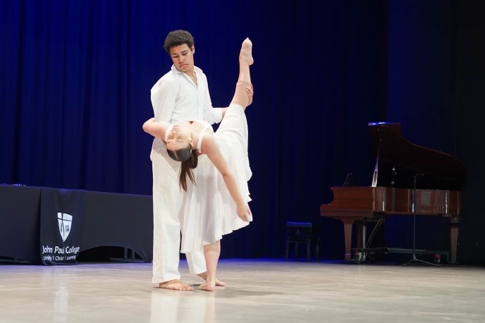 Kiyoshi and another student, both wearing white costume, doing contemporary dance at JPC