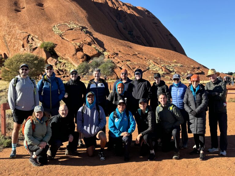 RACV and Davidson executive teams at the base of Uluru for the Yalari leadership camp