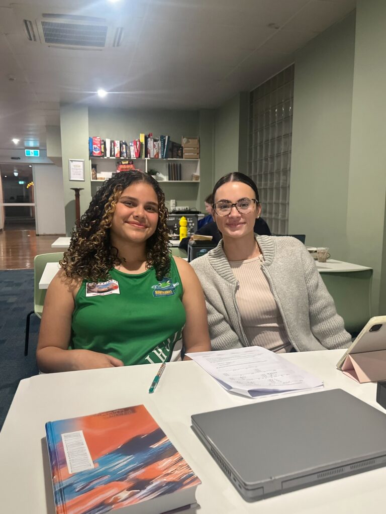 Volunteer Rosie Gallagher tutoring Yalari student Alynah at Clayfield College